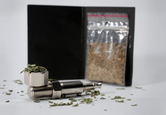 Synthetic cannabis and a pipe.