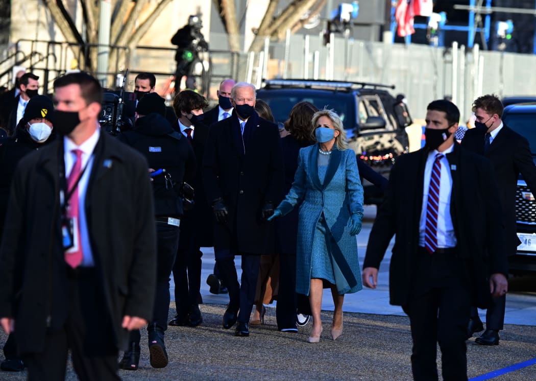 US President Joe Biden (C L) and First Lady Jill Biden walk in front of the White House in Washington, DC, on January 20, 2021.