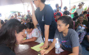 Saipan residents queue for post-typhoon aid at the American Memorial Park, Northern Marianas.