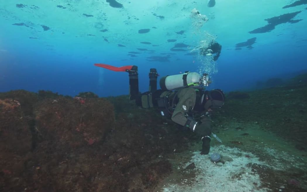 Divers collecting sample to measure methane at Cape Evans, Antarctica. Single use