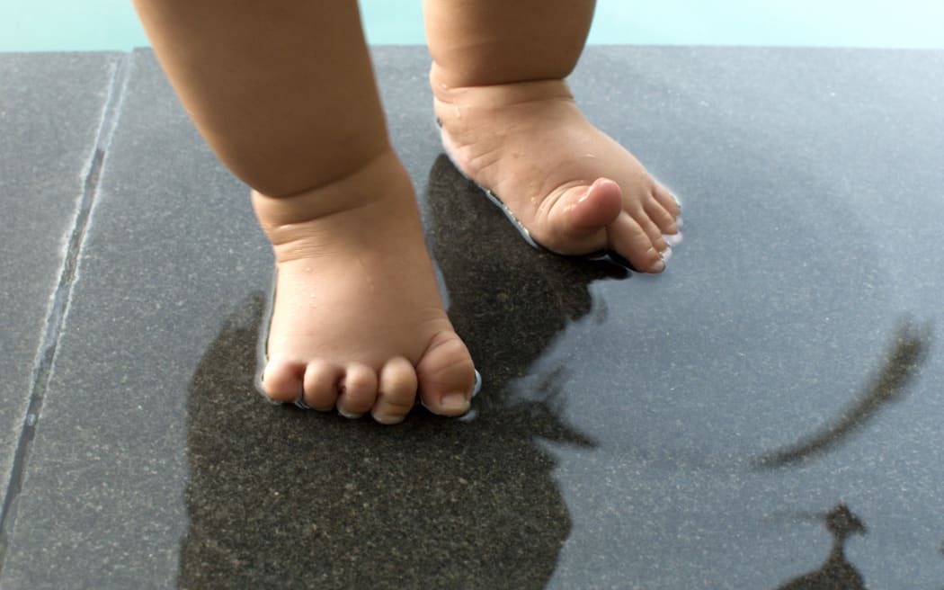 A baby's feet in the pool