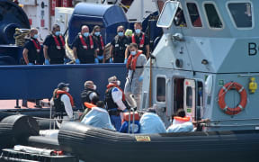 UK Border Force officers come to meet migrants, believed to have been picked up from boats in the Channel, from Coastal patrol vessel "HMC Speedwell", in the port of Dove.