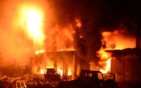 Flames and smoke rise from building after a fire broke out in an old part of the Bangladeshi capital Dhaka on February 21, 2019.