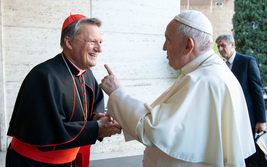 This handout picture taken and released on October 9, 2021 by Vatican Media shows Pope Francis (R) speaking with Cardinal Mario Grech of Malta during the opening of the Synod at the Vatican. (Photo by VATICAN MEDIA / AFP) / RESTRICTED TO EDITORIAL USE - MANDATORY CREDIT "AFP PHOTO/ VATICAN MEDIA" - NO MARKETING - NO ADVERTISING CAMPAIGNS - DISTRIBUTED AS A SERVICE TO CLIENTS - RESTRICTED TO EDITORIAL USE - MANDATORY CREDIT "AFP PHOTO/ VATICAN MEDIA" - NO MARKETING - NO ADVERTISING CAMPAIGNS - DISTRIBUTED AS A SERVICE TO CLIENTS /