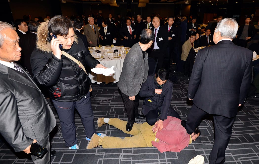 Political activist Kim Ki-Jong is arrested following his knife attack on US ambassador to South Korea Mark Lippert.