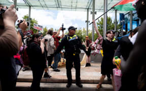 Police interrupted the crowd and moved people back from the stage following a "threat".