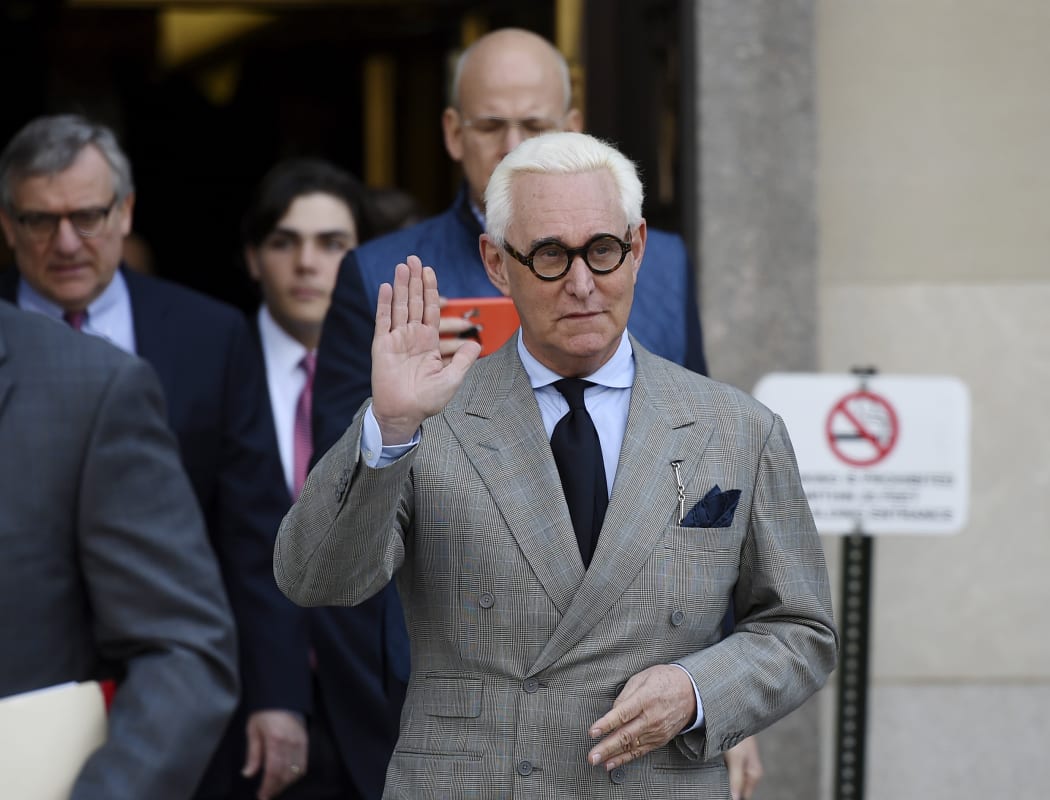 Roger Stone in  March 14, 2019 waves as he leaves a court hearing in Washington DC.