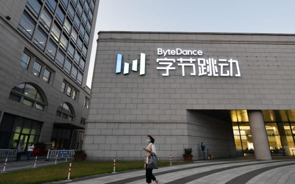 A woman walks past the headquarters of ByteDance, the parent company of video sharing app TikTok, in Beijing on September 16, 2020. Silicon Valley tech giant Oracle is "very close" to sealing a deal to become the US partner to Chinese-owned video app TikTok to avert a ban in the United States, President Donald Trump said on September 15. (Photo by GREG BAKER / AFP)