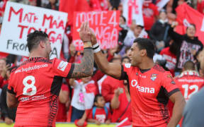 Tonga's Andrew Fifita and Tevita Pangai Junior celebrate their upset win over the Kiwis at the 2017 World Cup.