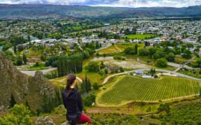 A person looks at the view over Alexandra, in Central Otago, on a sunny day.