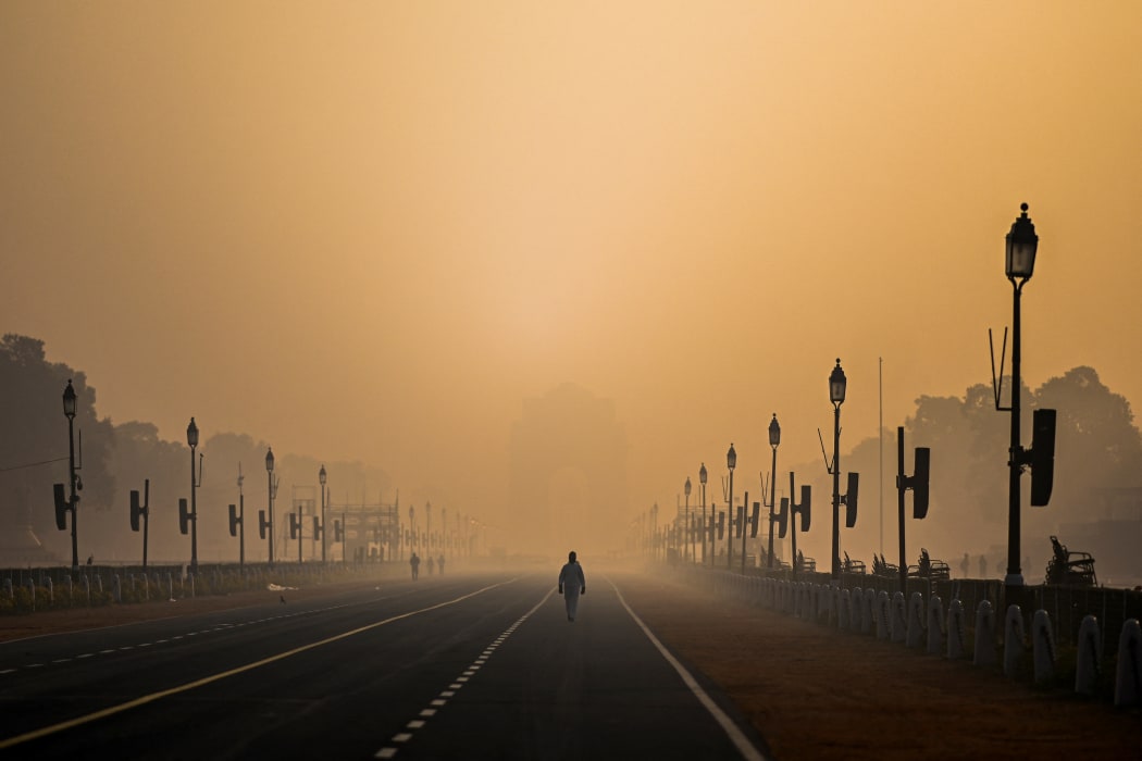 A man walks along Rajpath amid smoggy conditions in New Delhi on January 28, 2021.