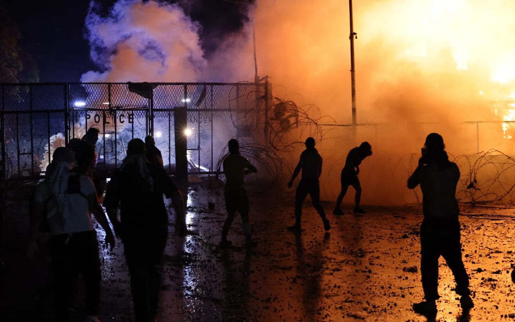 Protesters clash with Lebanese security forces on October 18, 2023, outside the US Embassy during a demonstration in solidarity with the people of Gaza in Awkar, East of Beirut, after a strike on a hospital in the Gaza Strip killed at least 200 people on October 17, 2023. The Israeli army said on October 17 a strike which hit a Gaza hospital, killing at least 200 people according to Hamas officials, was a rocket misfired by Palestinian militants. Lebanon's Iran-backed Hezbollah movement called for a "day of rage" to condemn the strike as hundreds of demonstrators gathered at the French and US embassies in protest. (Photo by JOSEPH EID / AFP)