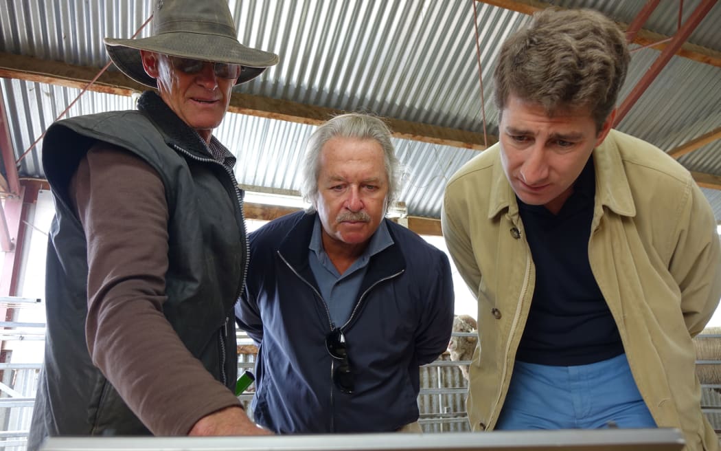 The owner of Earnscleugh High Country Satation, Alistair Campbell, shows Italian textile magnate Dr Pier-Luigi Loro Piana, and Loro Piana CEO Matthieu Brissett how computer technology has helped breed Merino sheep.