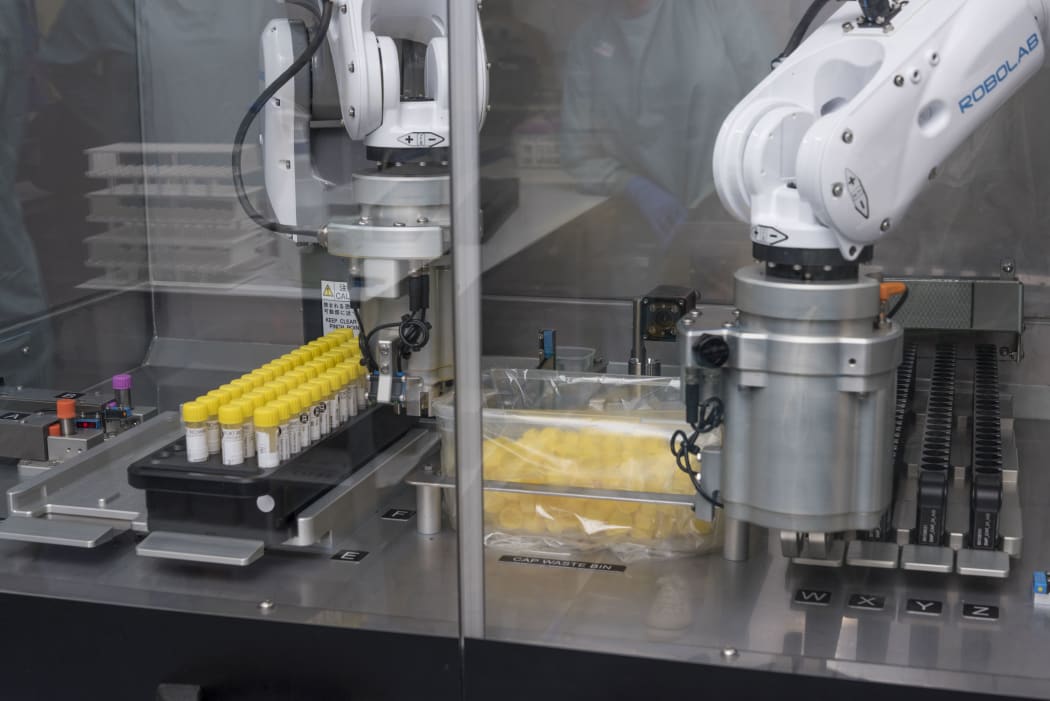 A de-capping robot, which has mechanical arms that unscrew sample tube caps ready for processing and then replaces with a new cap when processing is completed. It is designed to boost workflow and reduce the risk of repetitive strain injuries for Covid-19 testing labs.