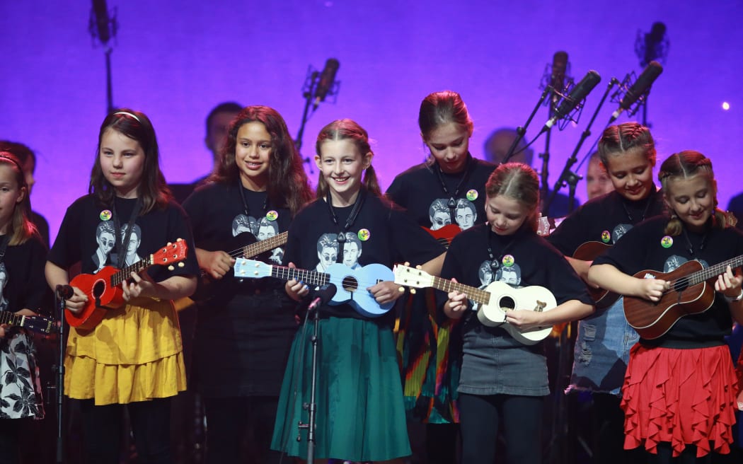 Children from the Kiwileles programme playing ukuleles