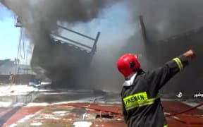 Firefighters combatting a blaze at the Delvar Kashti Bushehr boat factory in the Iranian city of Bushehr.