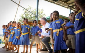 Speaker Trevor Mallard learns some new dance moves from the children at Koroipita Kindergarten in Fiji