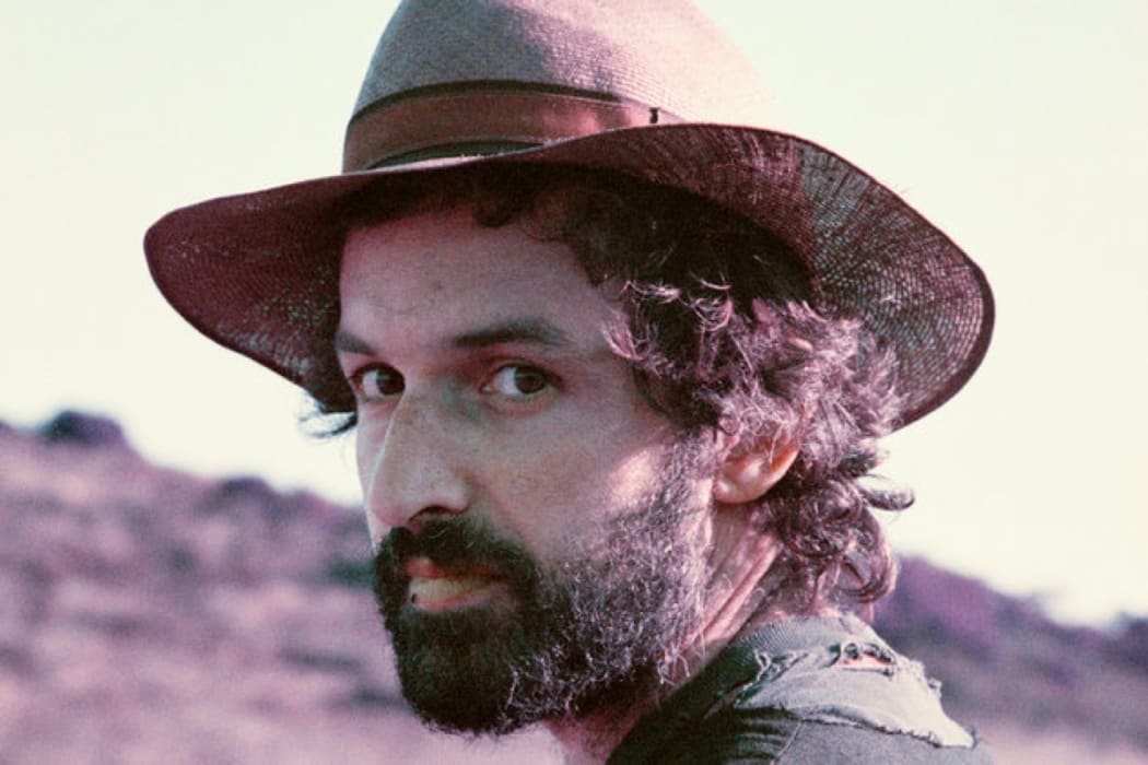 Joachim Cooder poses in the desert wearing a hat