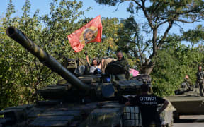 Pro-Russian fighters sit on a tank in southeast of Donetsk, August 31.