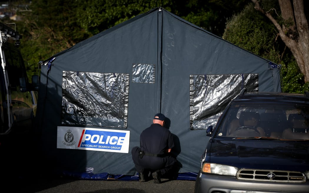 Police erect a forensic tent at the cordon down Broderick Crescent.