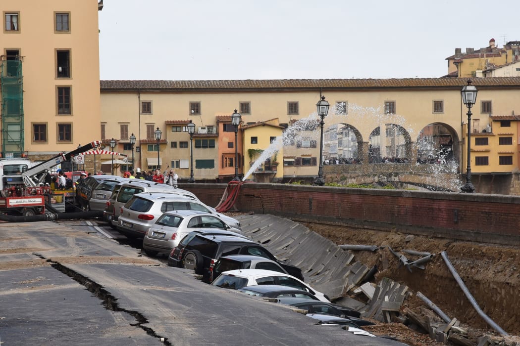 The hole swallowed up many parked cars.