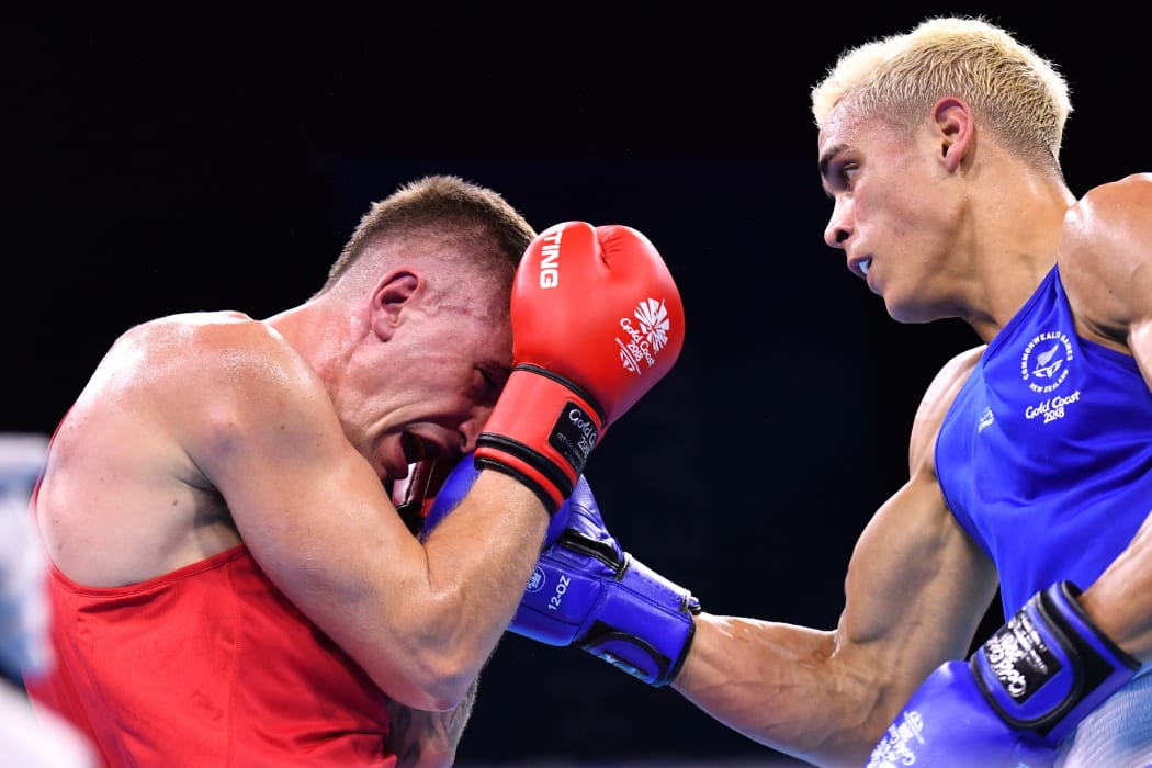 New Zealand's David Nyika (R) punches Australia's Jason Whateley during their men's 91kg final boxing match during the 2018 Gold Coast Commonwealth Games at the Oxenford Studios venue on the Gold Coast on April 14, 2018. / AFP PHOTO / Anthony WALLACE