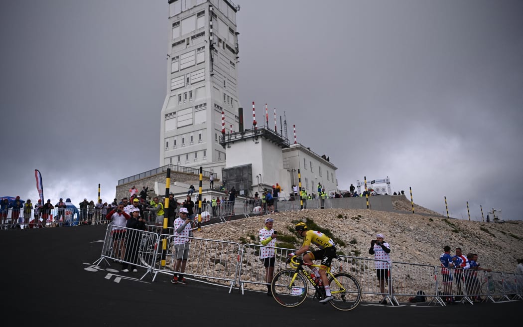 Team UAE Emirates' Tadej Pogacar of Slovenia wearing the overall leader's yellow jersey climbs the Mont Ventoux during the 11th stage of the 108th edition of the Tour de France cycling race, 198 km between Sorgues and Malaucene, on July 07, 2021. (Photo by Anne-Christine POUJOULAT / AFP)