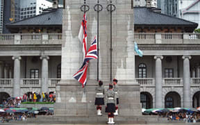 Three British soldiers lower the Union Jack for the last time at the Cenotaph monument in the Central district of Hong Kong on 30 June 1997, just hours prior to the end of some 156 years of British colonial rule as the territory returned to Chinese control.