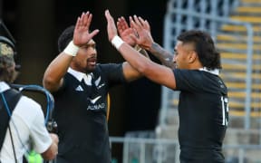 Rieko Ioane celebrates with Ardie Savea after scoring against the Wallabies in Sydney.