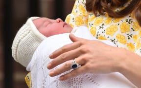 Catherine, Duchess of Cambridge holds her newly-born daughter.