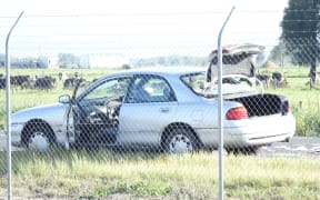 The car the man got out before pointing a rifle at the officers.