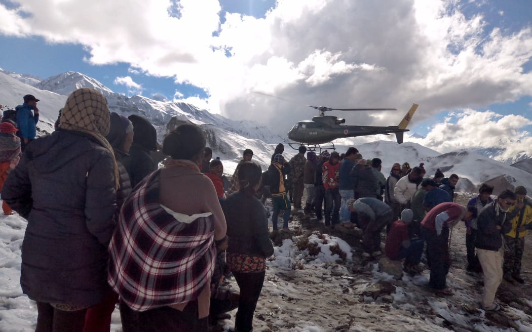 A Nepalese Army helicopter rescues survivors.