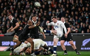Ben Spencer, kicks for England, against the All Blacks in the first test at Forsyth Barr Stadium, Dunedin, on 6 July 2024.