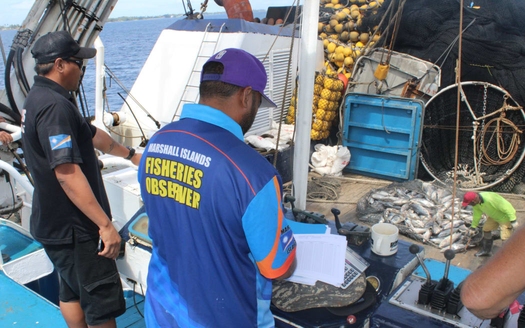 Marshall Islands Marine Resources Authority fisheries officers observe tuna transshipment from the purse seiner vessel Mathawmarfach, flagged to the Federated States of Micronesia in this file photo from 2024