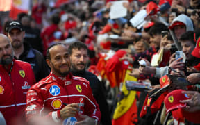 British F1 driver Lewis Hamilton signs autographs during the Scuderia Ferrari event in Milan, 2025.