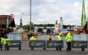 Security officers stand in front of the empty Theresienwiese grounds of the Oktoberfest beer festival on 1 October, 2025 in Munich, southern Germany, after the festival was closed over a bomb threat.