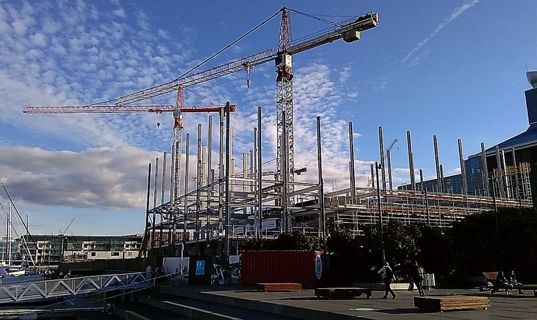 Construction with cranes against a blue sky