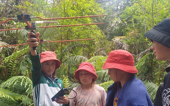Evelyn Colegate and class mates from Oakura School search for signals to track kiwi's movements