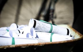 Copies of the petition for women's suffrage in a wheelbarrow outside Parliament on the 125th anniversary of the Electoral Act 1893 being signed into law.