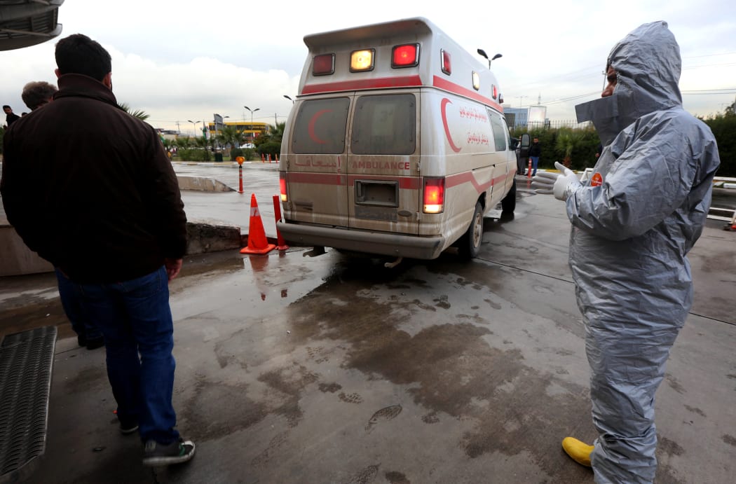 Medical staff receive patients as they arrive in ambulances at a hospital in Arbil, the capital of the Kurdish autonomous region in northern Iraq, on March 4, 2017, following a reported chemical attack.