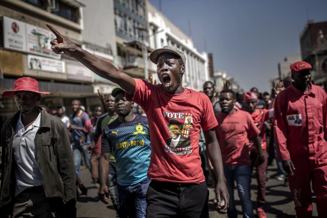 Supporters of the opposition party Movement for Democratic Change (MDC), protest against alleged widespread fraud by the election authority and ruling party, after the announcement of election's results, in the streets of Harare.
