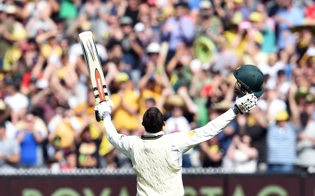 Australian batsman Usman Khawaja celebrates scoring his century against the West Indies on Boxing Day
