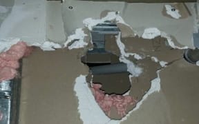 A photo of poor fire rating work that would let smoke and flames through.