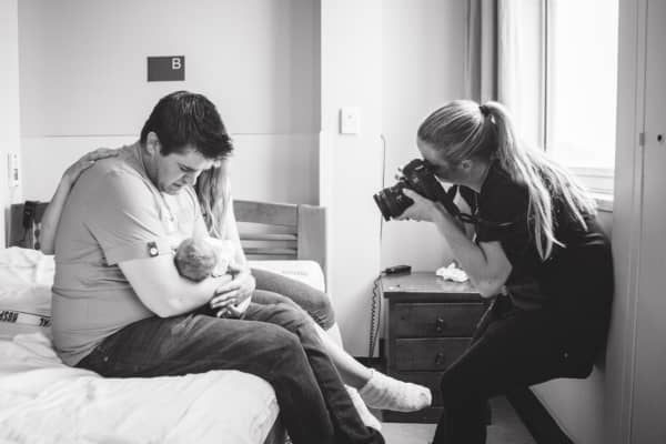 Emma MacDonald taking photos of baby Jasmine and her parents.