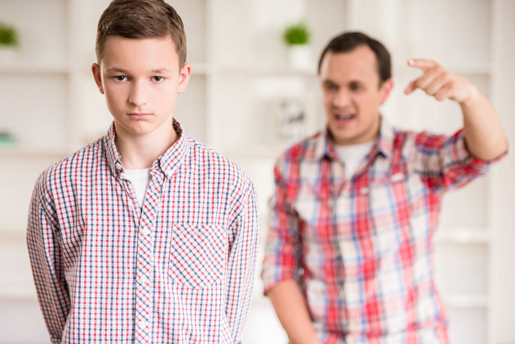 A photo of a father and son dressed having a quarrel at home.