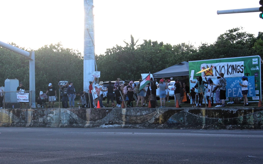 A group of demonstrators holding signs for the 2025 nationwide No King's rally.