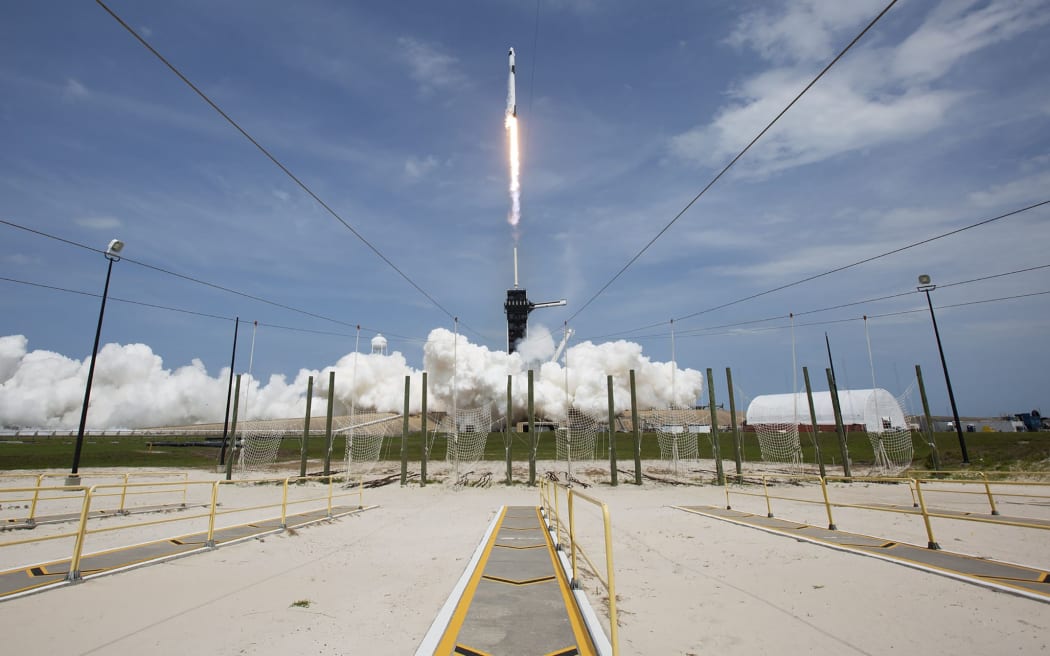 This NASA photo obtained May 31, 2020 shows a SpaceX Falcon 9 rocket carrying the company's Crew Dragon spacecraft launched to the International Space Station with NASA astronauts Robert Behnken and Douglas Hurley onboard,  on May 30, 2020, at NASAs Kennedy Space Center in Florida.