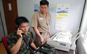 A South Korean uses the hotline to talk to North Korean officers in 2005.