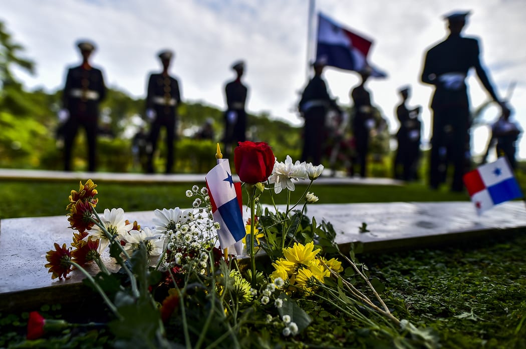 Members of Panama's presidential guard pay homage to victims of the 1989 US military invasion during a solemn ceremony commemorating the 30th anniversary.
