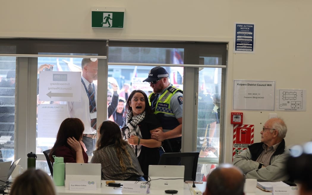 A protester is removed from the Kaipara District Council meeting. Credit: Michael Craig /NZM (LDR single use only)